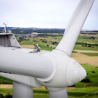 A DEKRA engineer on the top of a wind turbine.