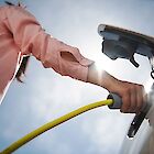 A person fills up an e-car.