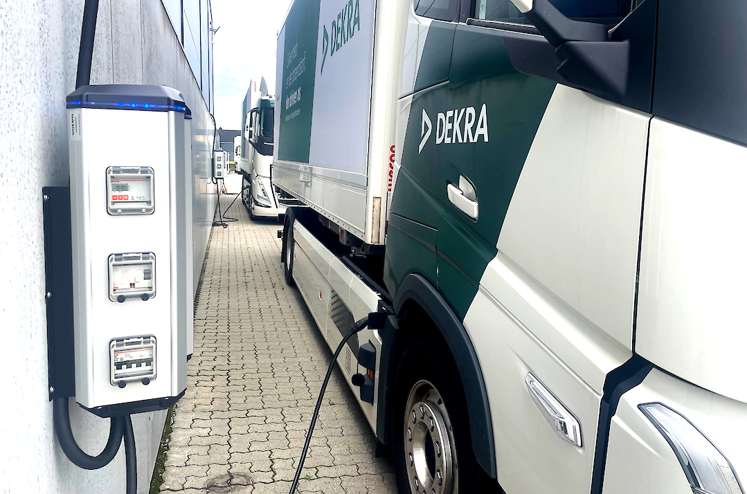 A truck is connected to an electric charging station.