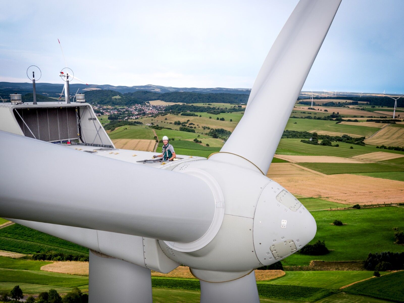 A DEKRA engineer on top of a wind turbine