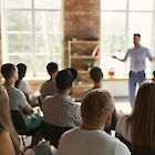 A man gives a lecture to a small audience.