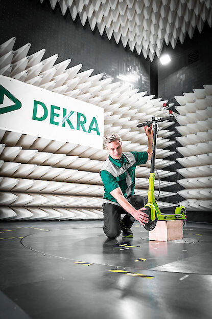 A DEKRA engineer checks an electric scooter.